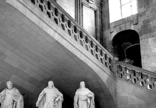 Three men under the stairs